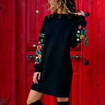 Black Sweatshirt pullover dress with floral embroidered sleeves.