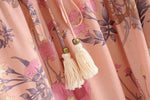 Close up image of Peach/ Pink Floral Print with tassels and beadwork shown.