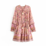 Pink Color option, Floral Printed Dress with Ruffles and tassels for that perfect pullover bohemian Women's short dress. Close up image of cinched elastic waist with bow and tassels.