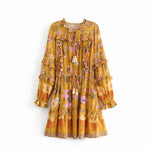Yellow Color option, Floral Printed Dress with Ruffles and tassels for that perfect pullover bohemian Women's short dress. Close up image of cinched elastic waist with bow and tassels.
