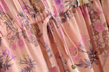 Pink Color option, Floral Printed Dress with Ruffles and tassels for that perfect pullover bohemian Women's short dress.  Close up image of cinched elastic waist with bow and tassels. 